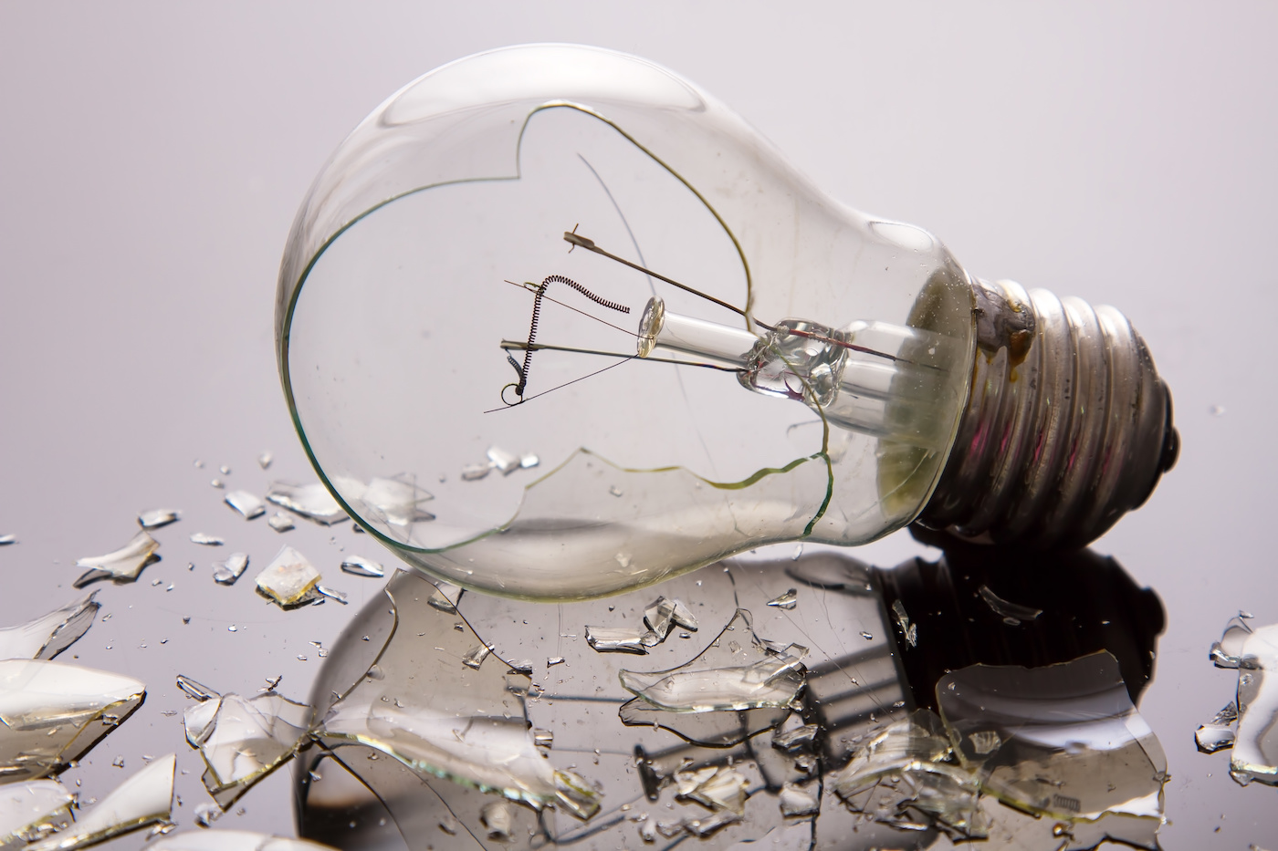 Broken light bulb on shiny surface